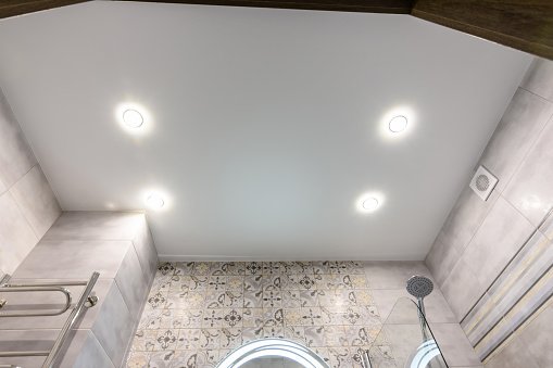 Stretched ceiling in a modern bathroom after renovation